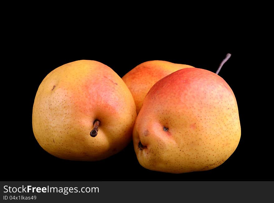 Yellow-red pears isolated on black; 3 pears