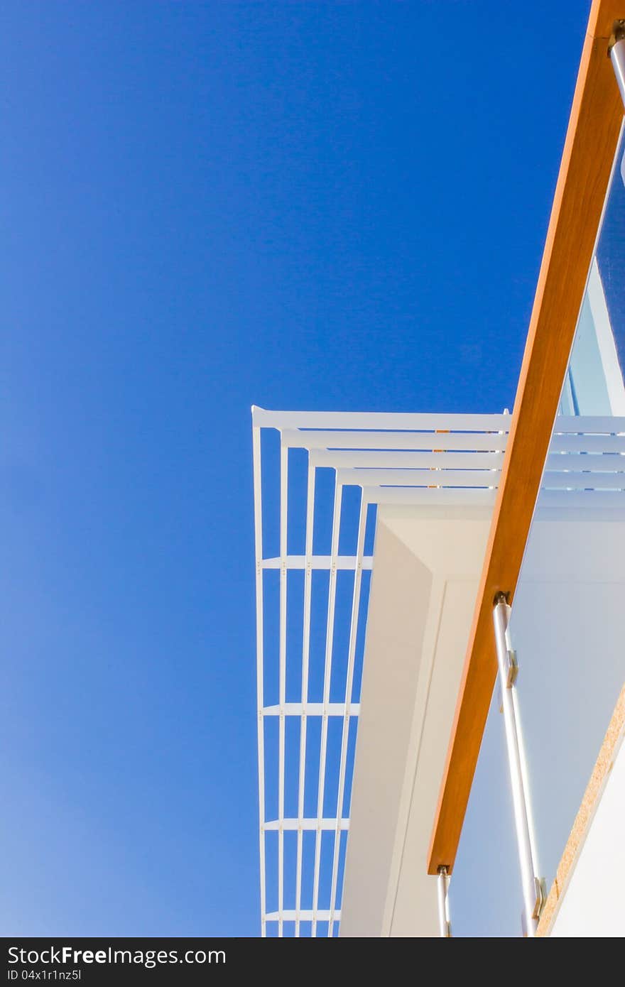 Modern style villa: louvers, handrail and blue sky