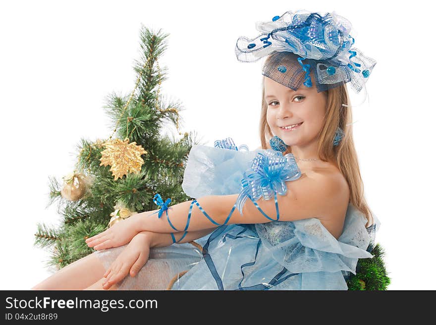 Portrait of a cute little girl in a beautiful dress and ornaments for the head against the Christmas tree. Portrait of a cute little girl in a beautiful dress and ornaments for the head against the Christmas tree