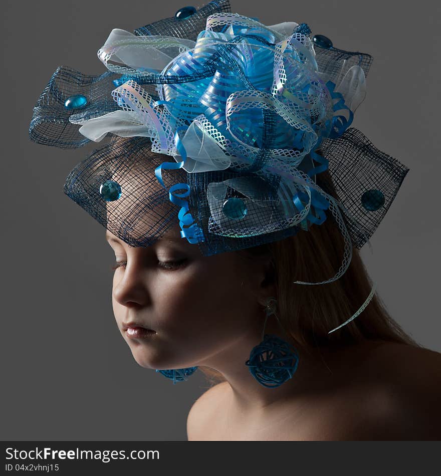 Close-up portrait of a pretty girl  in the decoration of elegant headdress posing in the studio. Close-up portrait of a pretty girl  in the decoration of elegant headdress posing in the studio