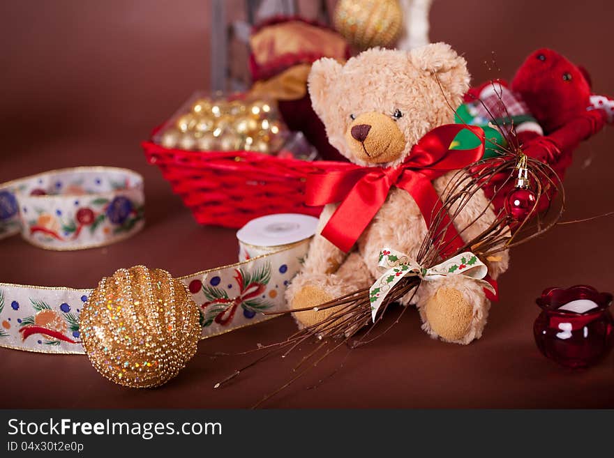 Christmas  teddy with basket for gifts on brown background with red ribbon. Christmas  teddy with basket for gifts on brown background with red ribbon