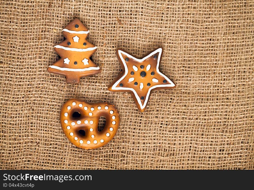 Three shapes of ginger bread cake, german lebkuchen on burlap background. Three shapes of ginger bread cake, german lebkuchen on burlap background