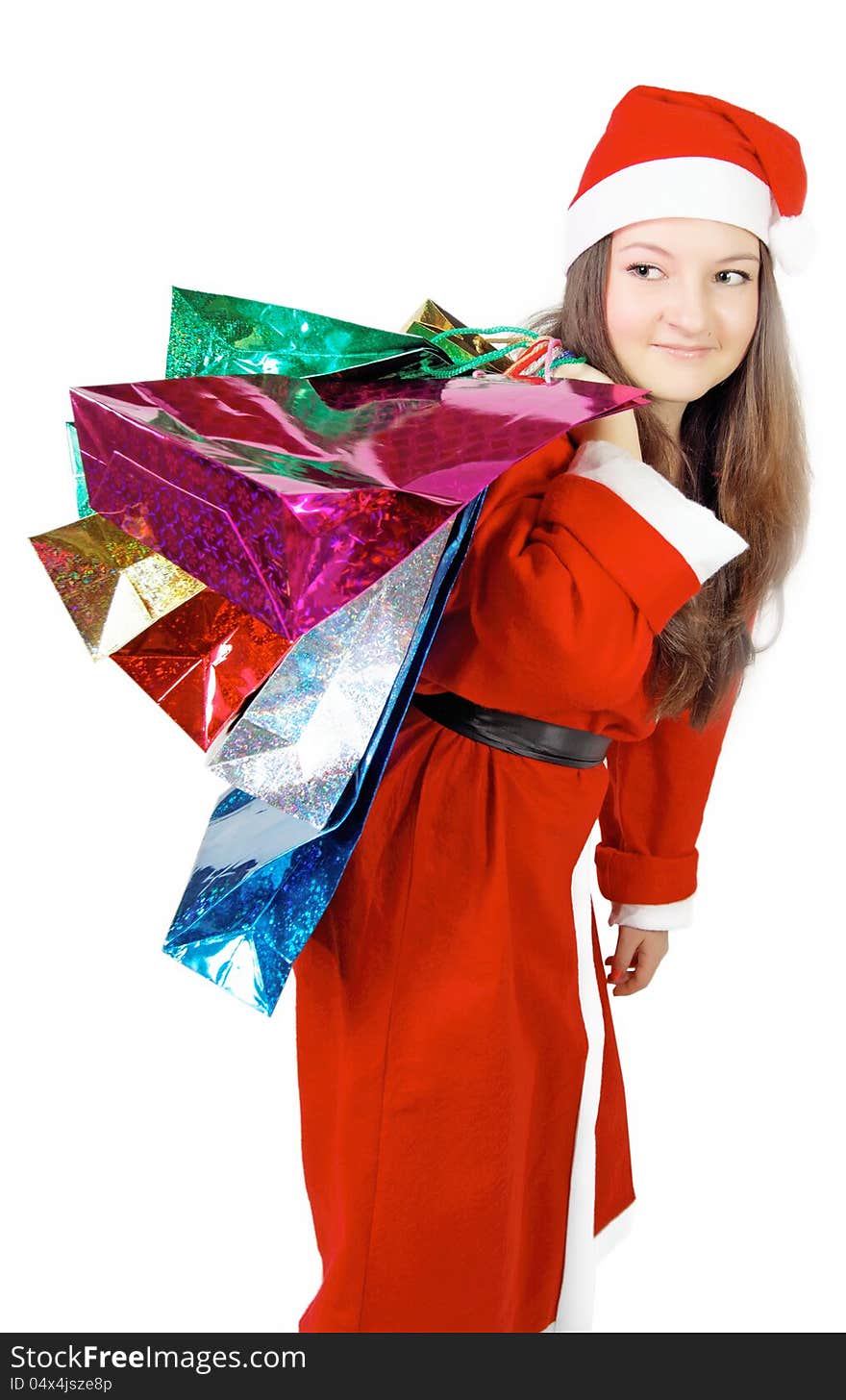 Cute young girl dressed as Santa brings gifts isolated. Cute young girl dressed as Santa brings gifts isolated