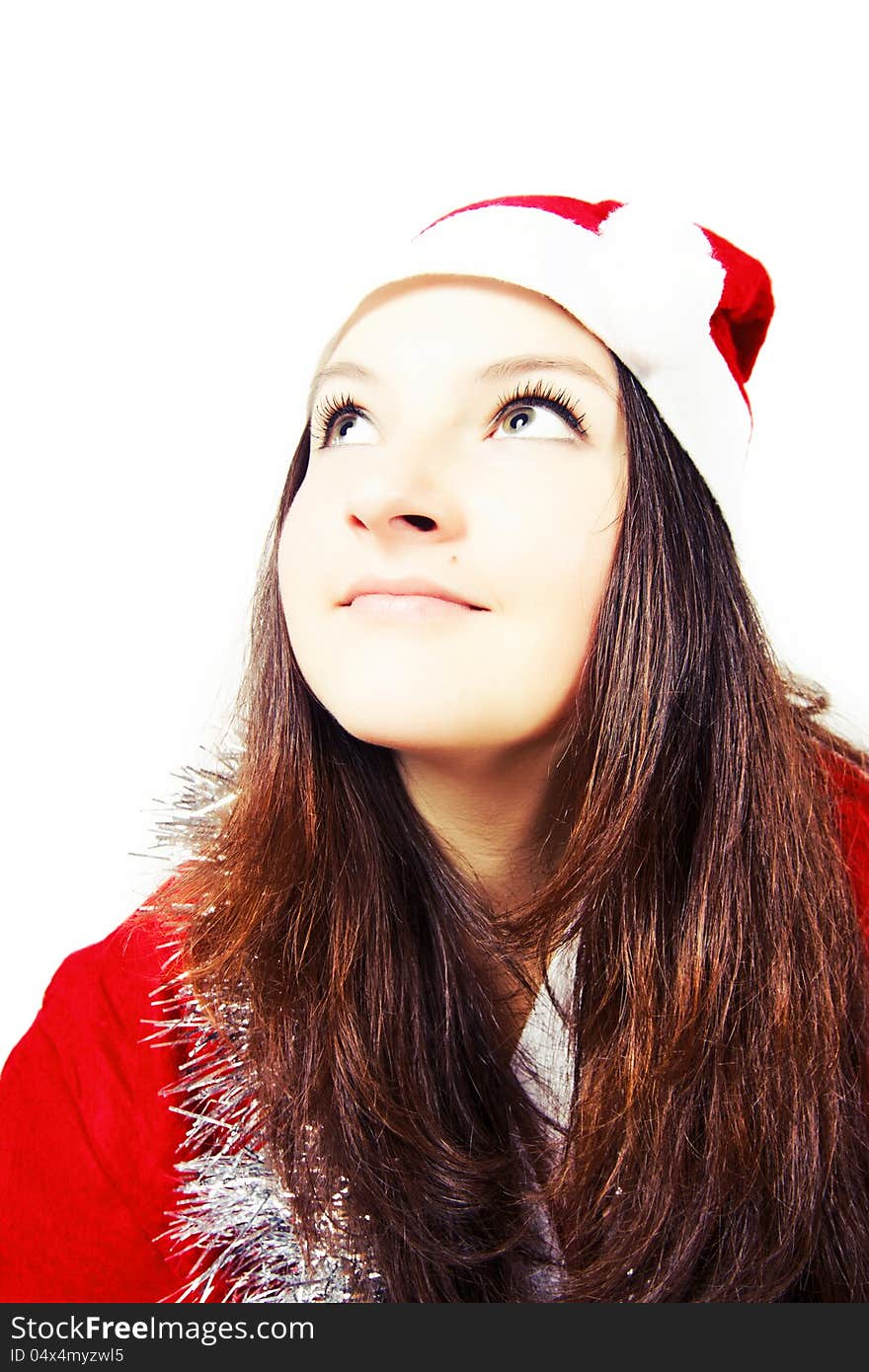 Portrait of a pretty young girl dressed as Santa isolated