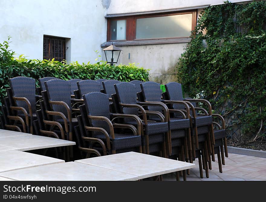 Stack Of Chairs In The Courtyard Restaurant