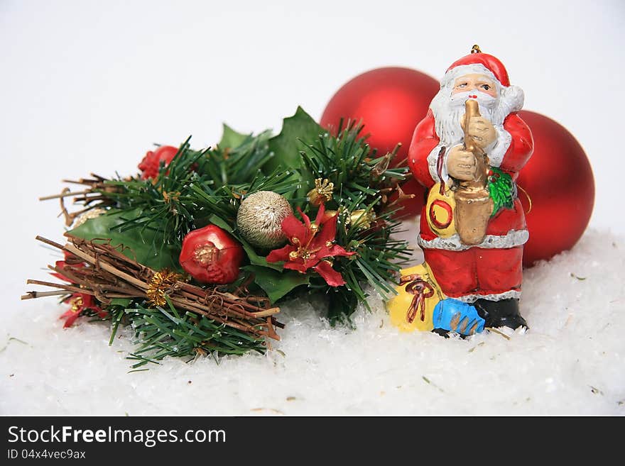 Santa Claus hat with tree ornaments, wreaths, on a red background