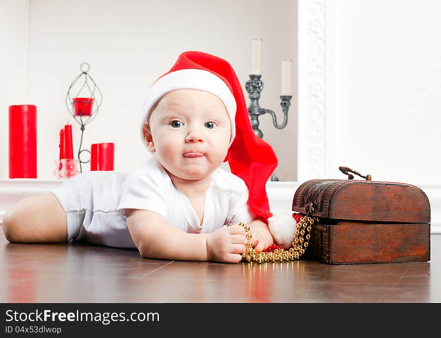 Close-up portrait of a little lying boy in christmas cap. Close-up portrait of a little lying boy in christmas cap