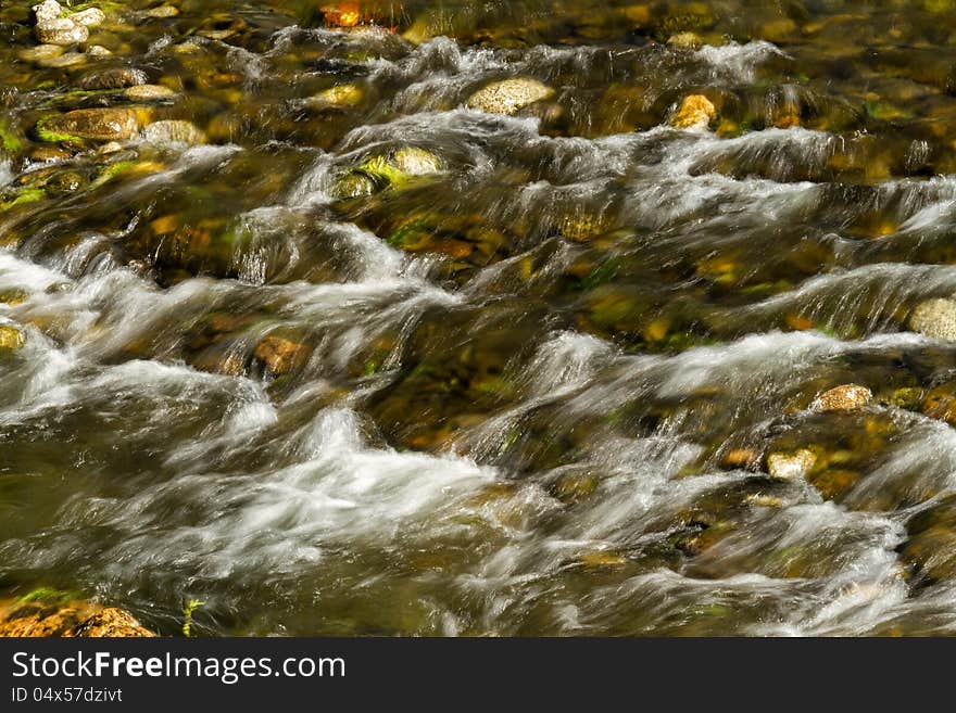 Beautiful veil cascading waterfall, mossy rocks. Beautiful veil cascading waterfall, mossy rocks