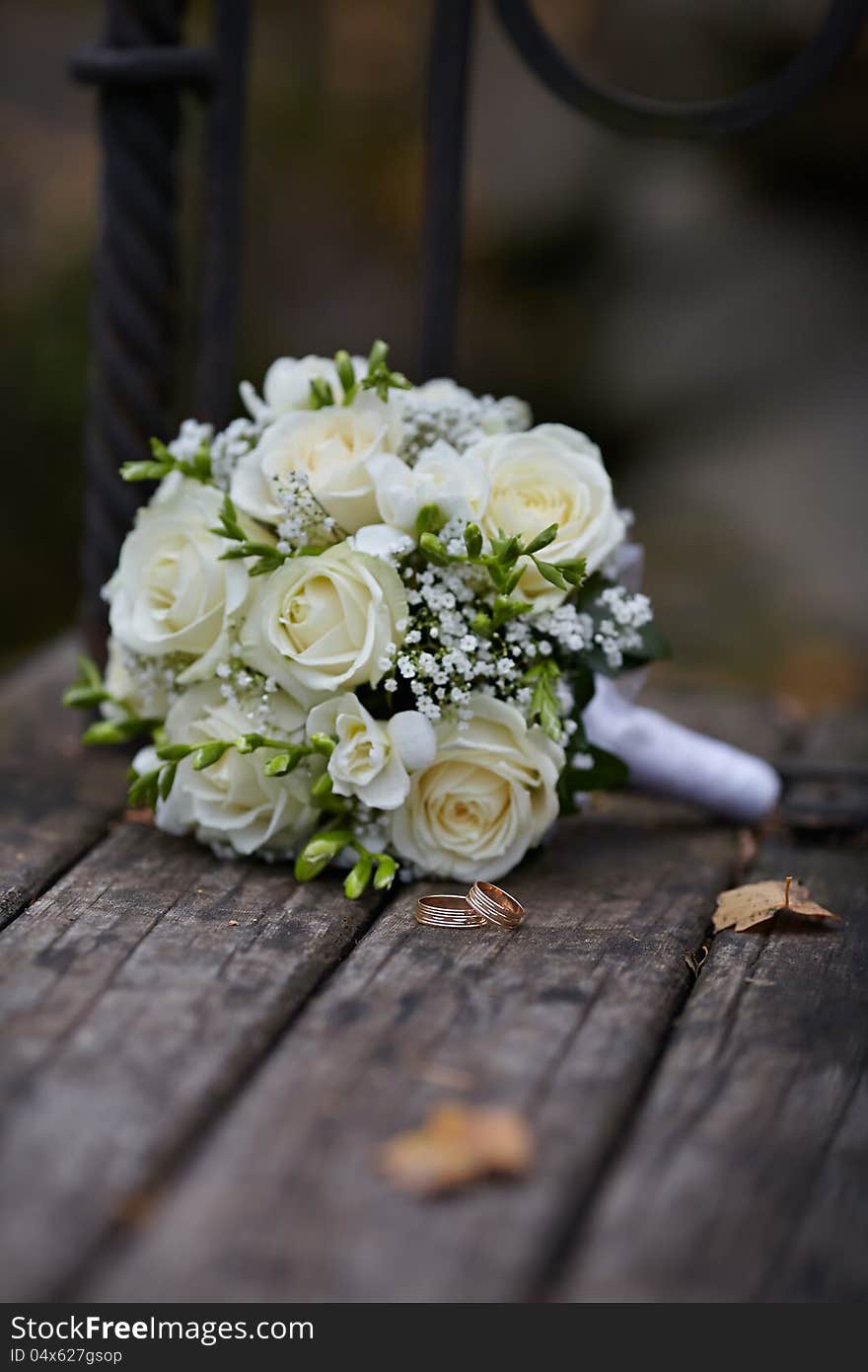 Wedding Rings and White Rose Bouquet