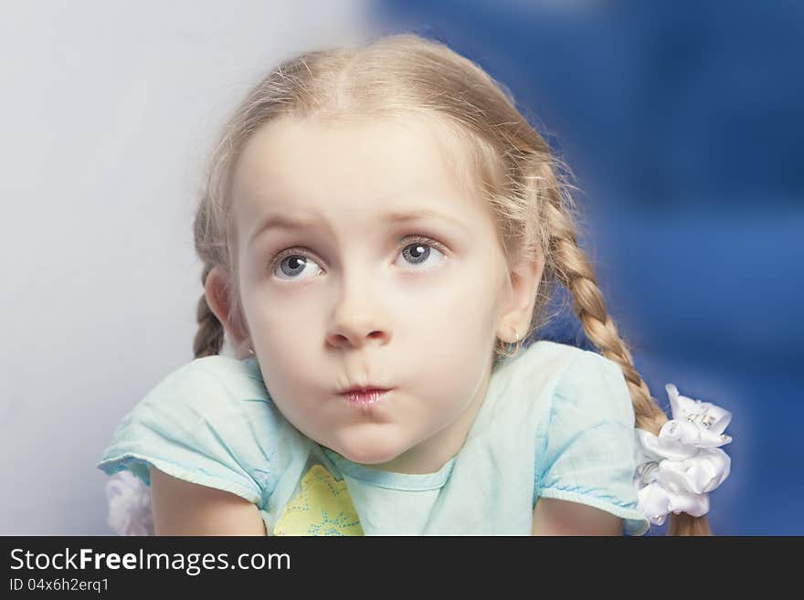 Pretty little caucasian girl loking aside indoors