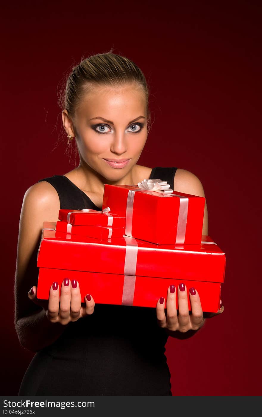 Girl In A Black Dress With Gifts In Hands