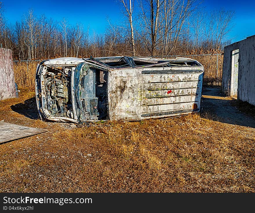 A old car in a paint ball area. A old car in a paint ball area