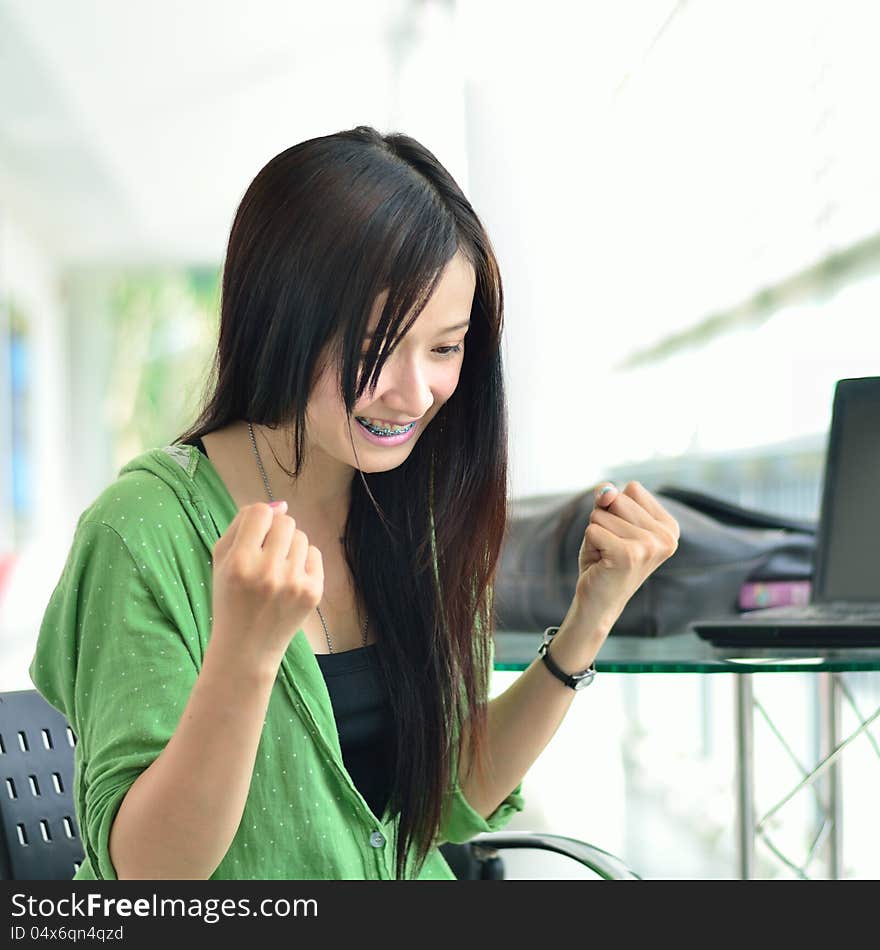 Close up of Asian girl smiling in success job