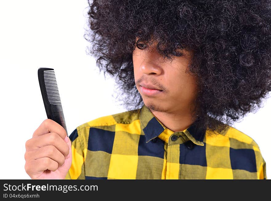 Close up of Young man with long hair make question form Comb as contrast concept. Close up of Young man with long hair make question form Comb as contrast concept