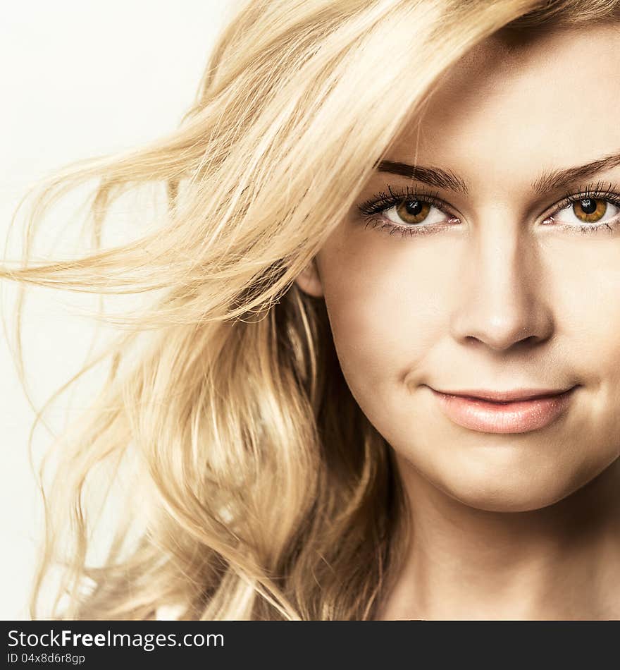 Fashion portrait of young beautiful woman posing in studio