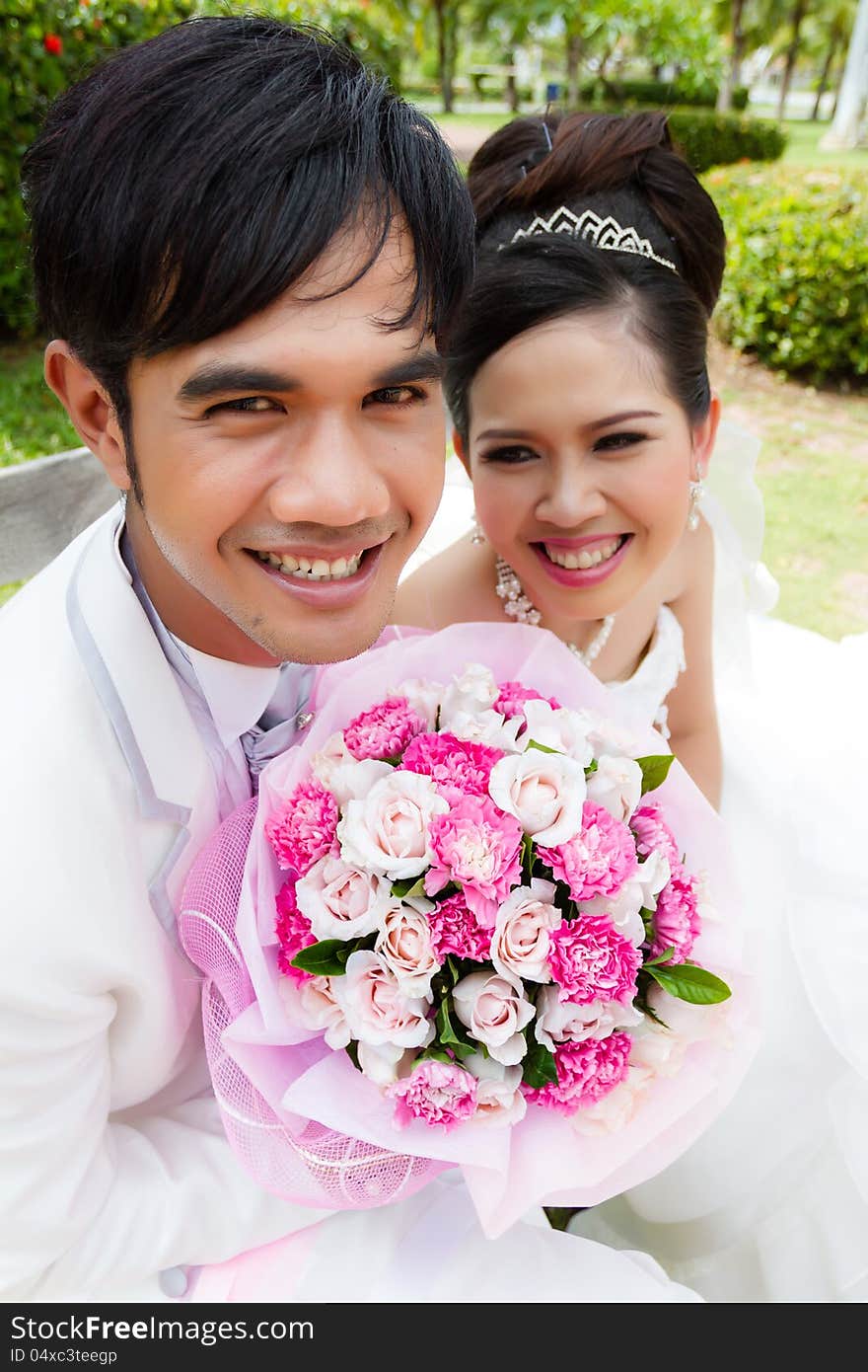 Wedding couple, with a bouquet of flowers