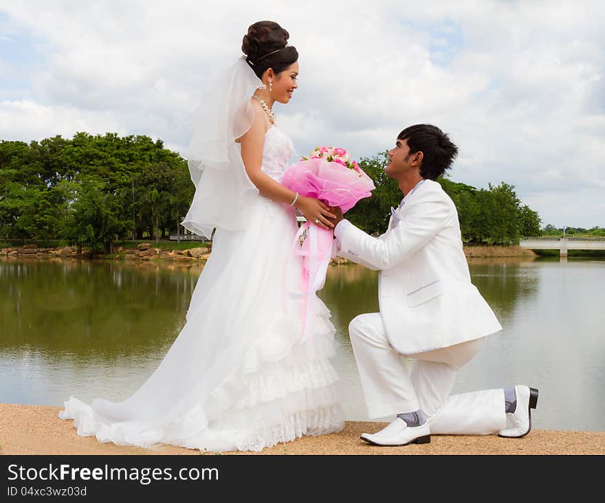 Wedding couple, with a bouquet of flowers