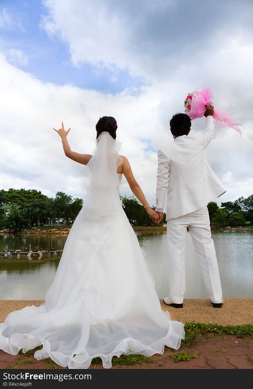 Wedding couple, with a bouquet of flowers