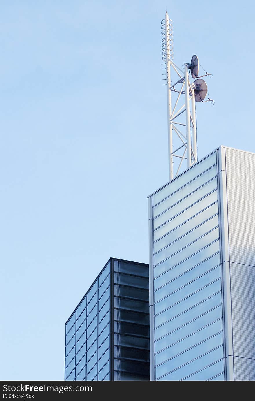 Modern office building with communication tower over them. Modern office building with communication tower over them