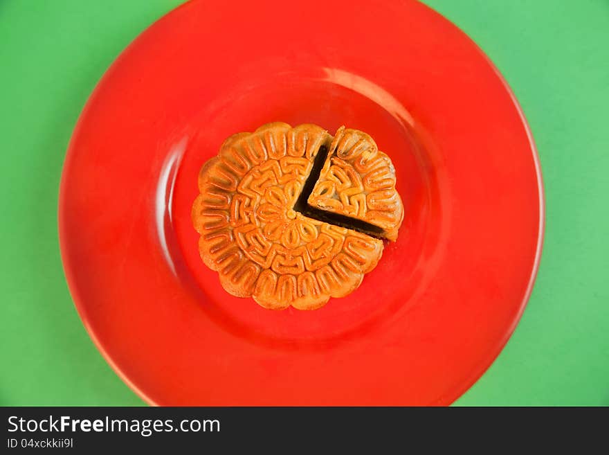 Chinese traditional moon cake in red plate. Chinese traditional moon cake in red plate