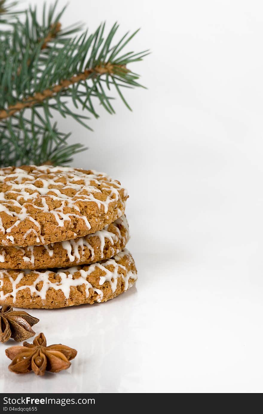 Border from sweets, spices and fur-tree branches on a white background