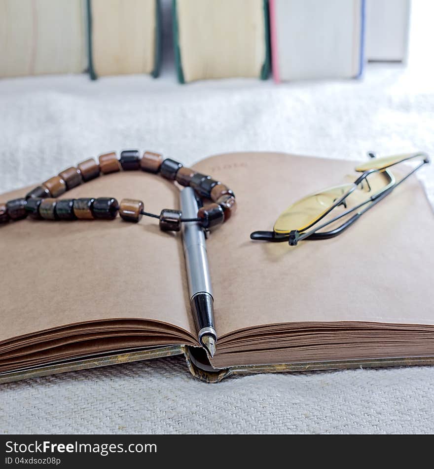 Close up photo of notebook and books on table