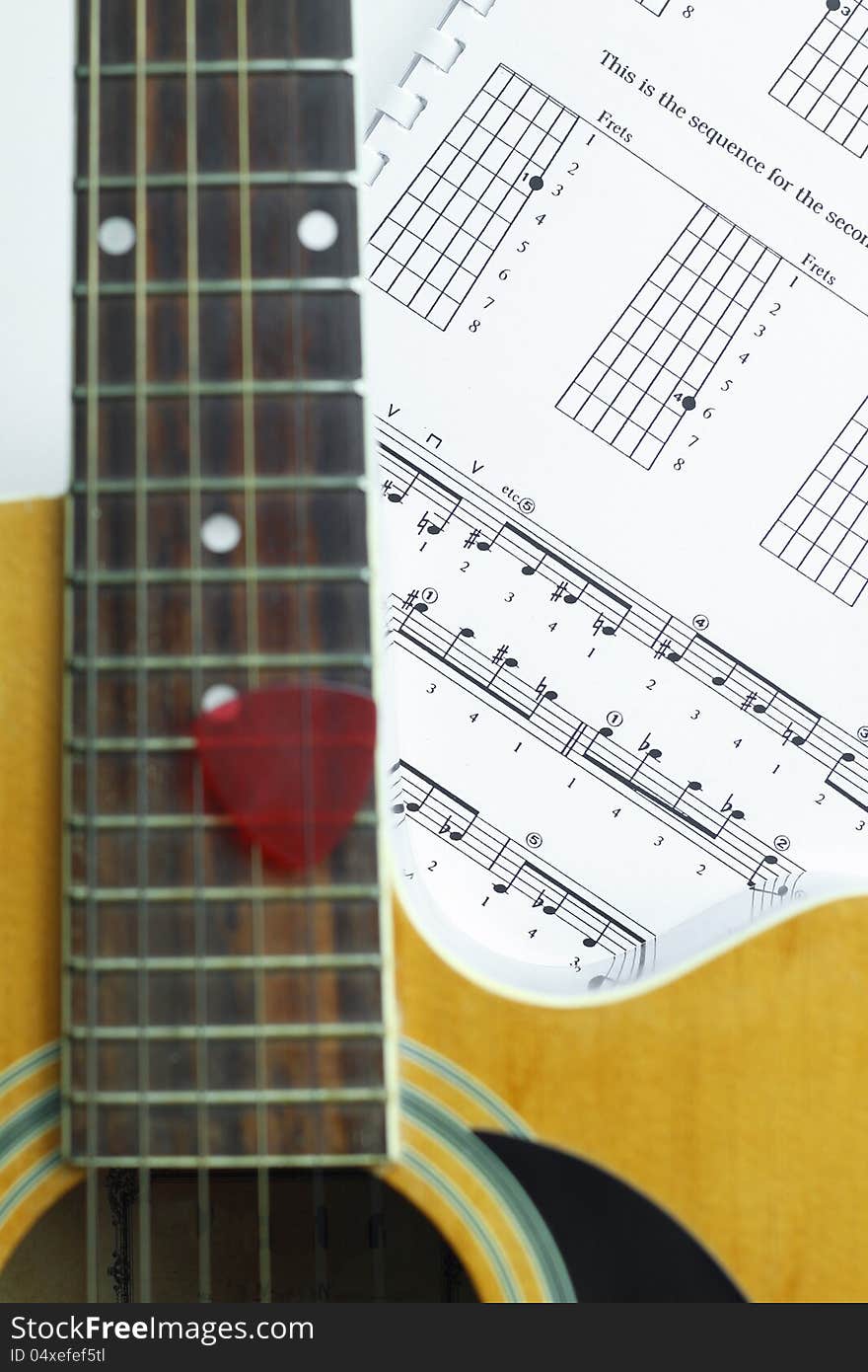 Acoustic Guitar on music note sheet