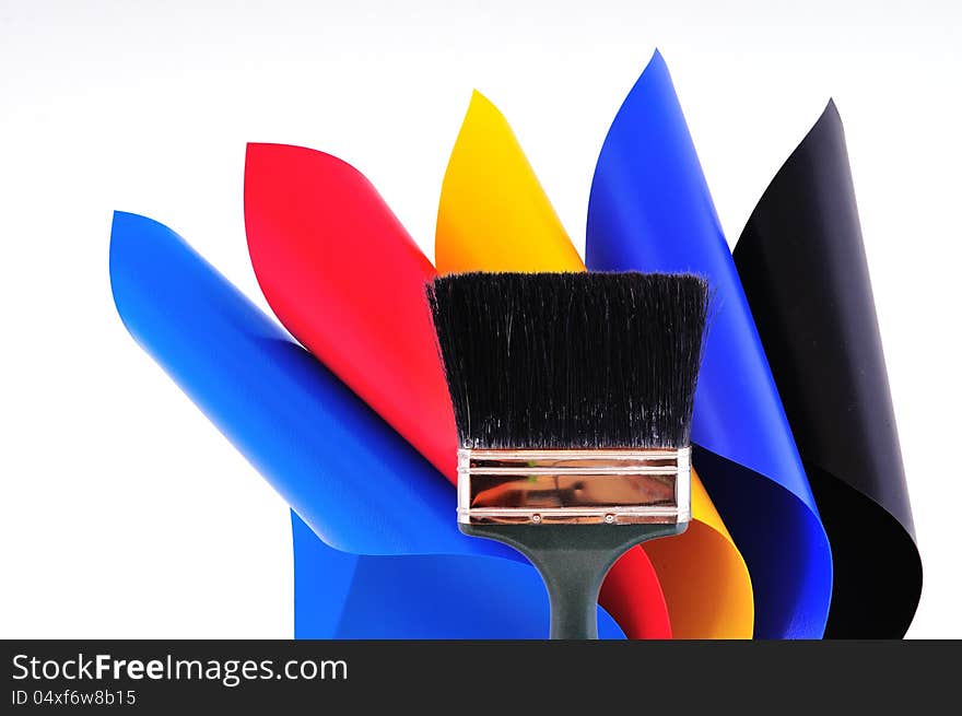 Rolls of colored sheets and Paint brush on their background all photographed on a white sheet. Rolls of colored sheets and Paint brush on their background all photographed on a white sheet