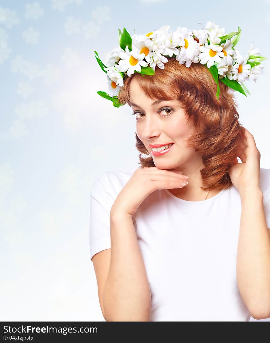 Beautiful woman in a wreath of flowers