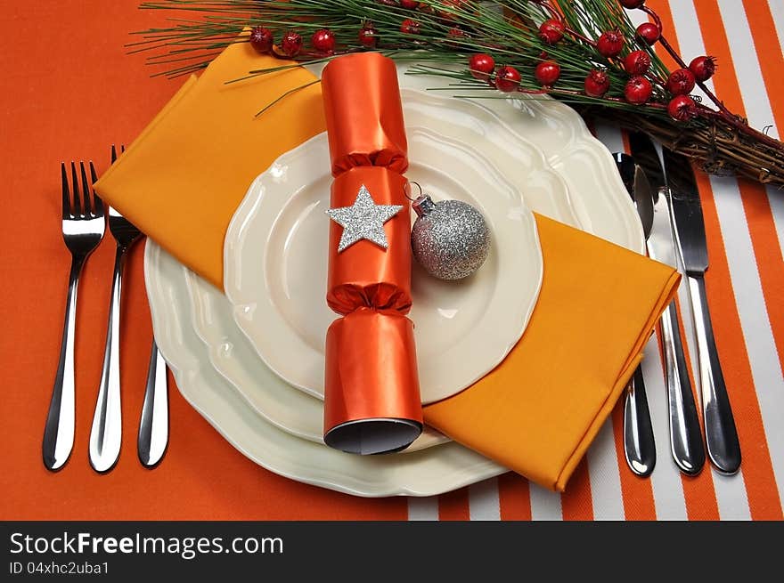 Bright and colorful Christmas table setting with plates, forks and knives, Christmas Bon Bons Crackers with decorations for a lively, stylish and fun holiday party atmosphere. Bright and colorful Christmas table setting with plates, forks and knives, Christmas Bon Bons Crackers with decorations for a lively, stylish and fun holiday party atmosphere.