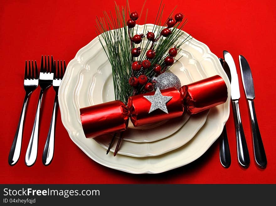 Bright and colorful Christmas table setting with plates, forks and knives, Christmas Bon Bons Crackers with decorations for a lively, stylish and fun holiday party atmosphere. Bright and colorful Christmas table setting with plates, forks and knives, Christmas Bon Bons Crackers with decorations for a lively, stylish and fun holiday party atmosphere.