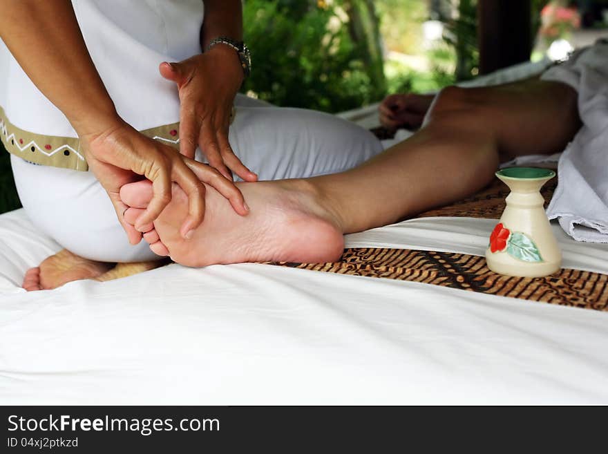 A detail image of a female leg being massaged. A detail image of a female leg being massaged