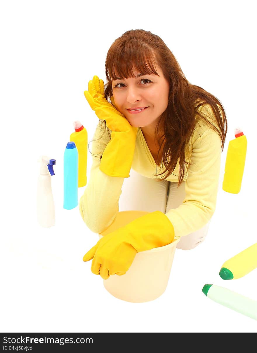 Smiling woman on the floor with plastic bucket and many bottles around her, isolated on a white background. Smiling woman on the floor with plastic bucket and many bottles around her, isolated on a white background.