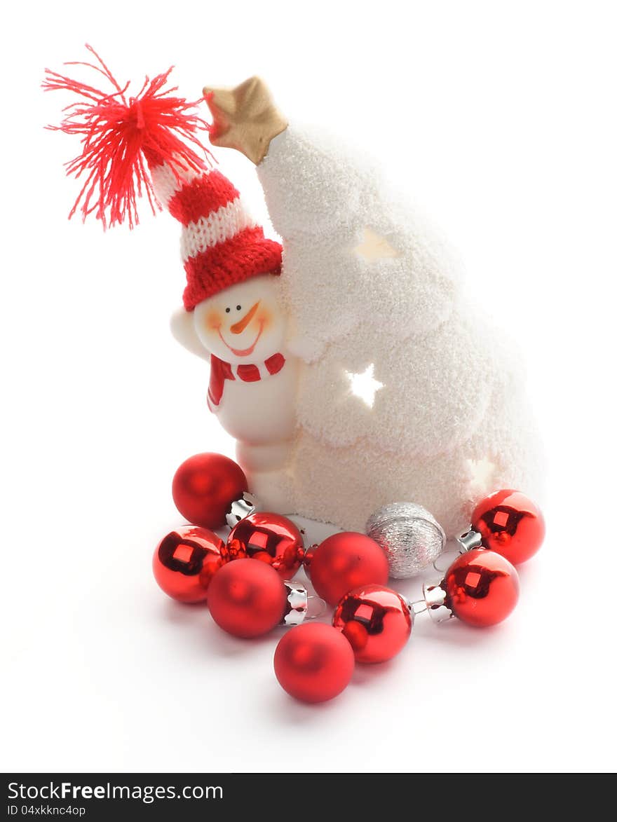 Snowman in Knitted Hat, Snow House and Red Little Baubles closeup on white background. Snowman in Knitted Hat, Snow House and Red Little Baubles closeup on white background