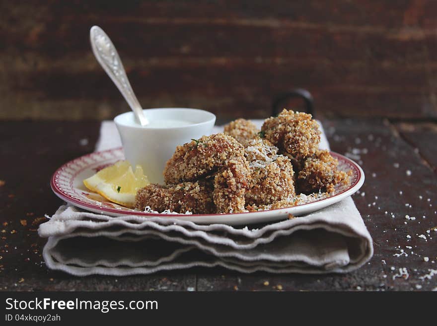 Chicken pieces in parmesan and bread crumbs with cream and lemon sauce