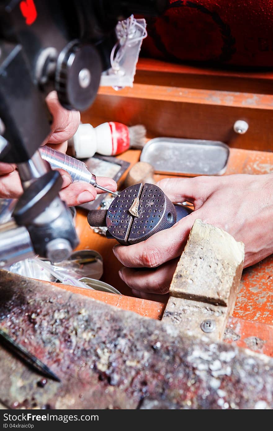 Jeweler creating a new golden masterpiece