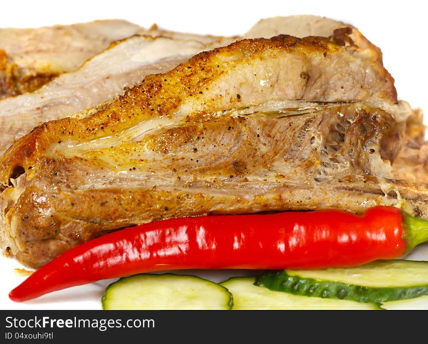 Baked meat on a plate with vegetables