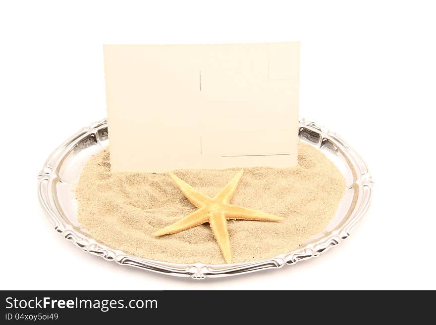 Serving plate of postcard and shell on the sand of the sea. Serving plate of postcard and shell on the sand of the sea.