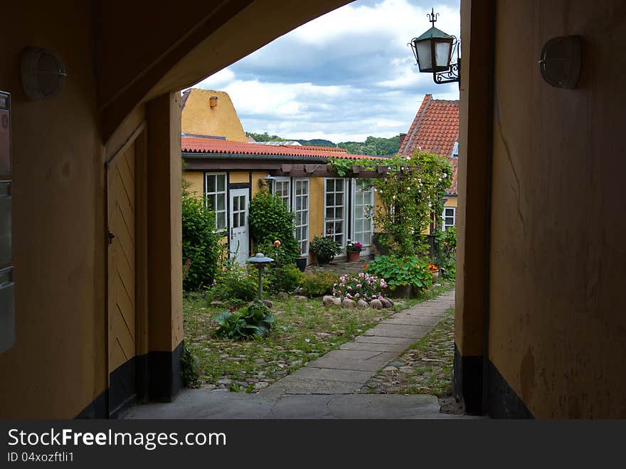 Traditional classical Danish small city house blooming garden. Traditional classical Danish small city house blooming garden