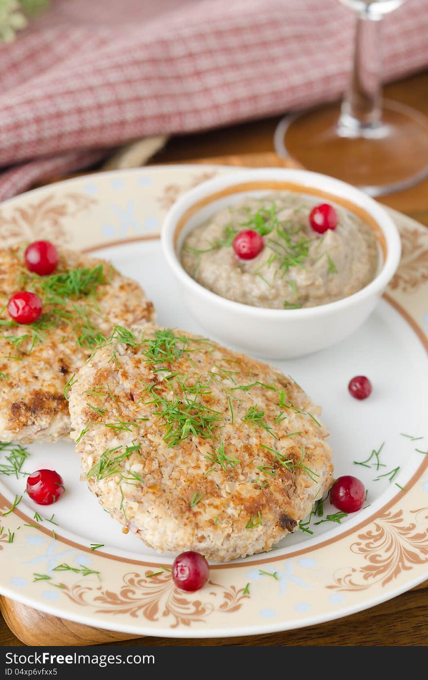 Chicken cutlets with cowberry and mushroom sauce closeup selective focus