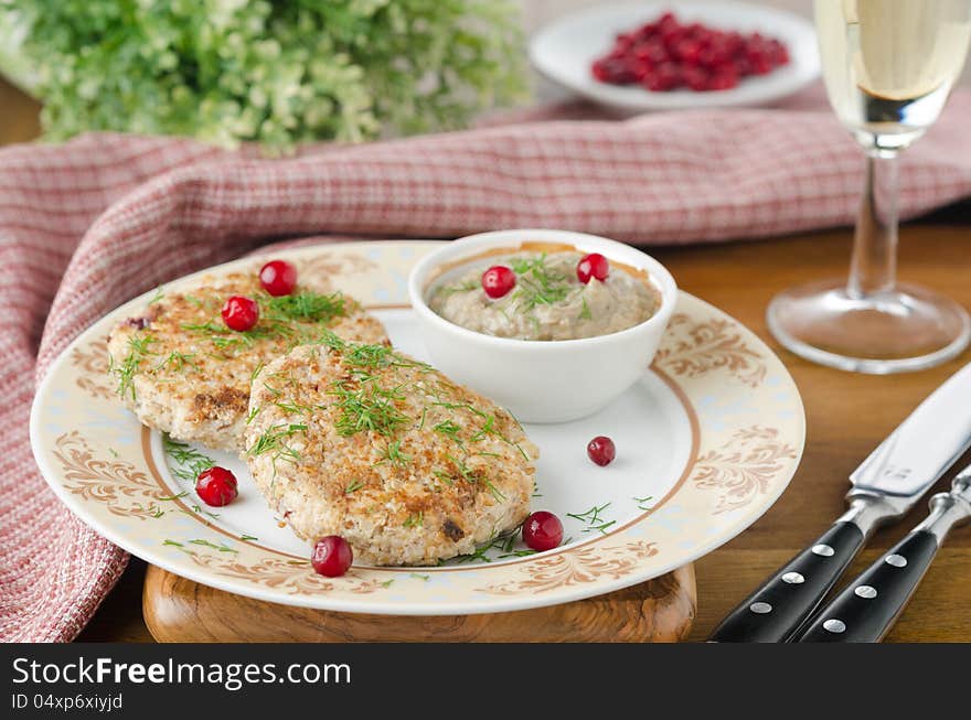 Chicken cutlets with cowberry and mushroom sauce to decorated table