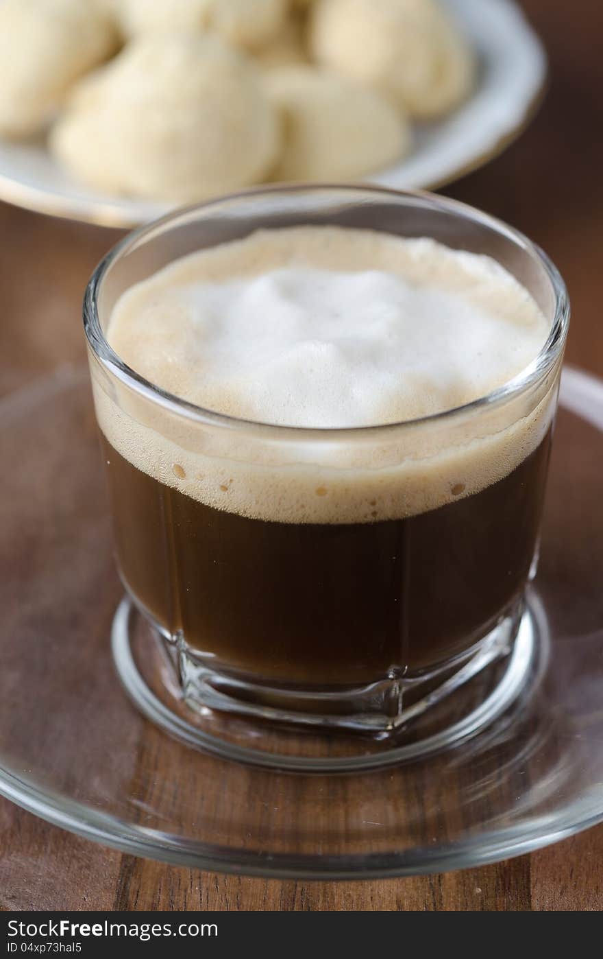 Glass Cup Of Coffee With Froth With Shortbread