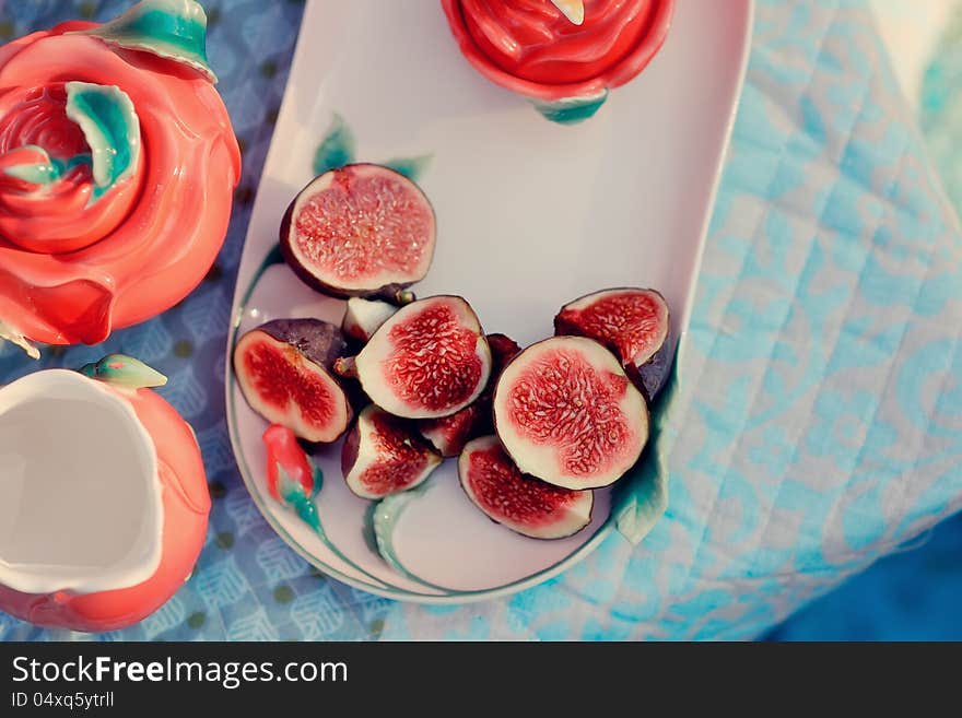 Still life - red, juicy pomegranate and fresh, ripe figs. Still life - red, juicy pomegranate and fresh, ripe figs