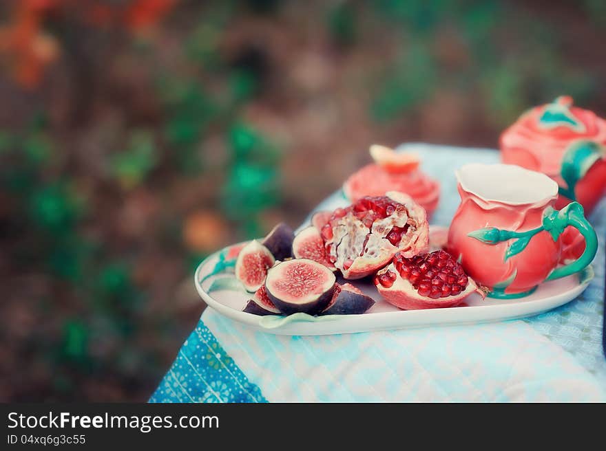 Still life - red, juicy pomegranate and fresh, ripe figs. Still life - red, juicy pomegranate and fresh, ripe figs