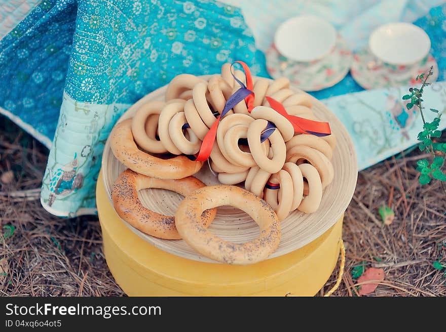 On the plate are rosy bread and vanilla bunch of bagels. On the plate are rosy bread and vanilla bunch of bagels