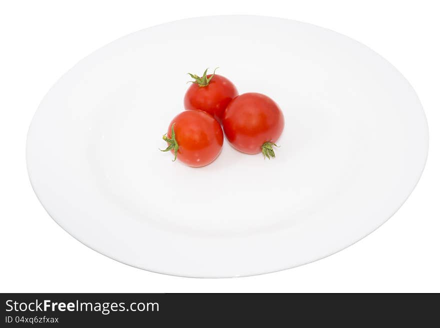 Tomato in a plate, isolated and closeup