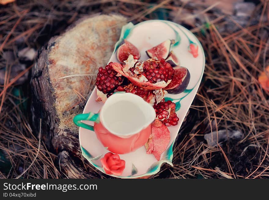 Still life - red, juicy pomegranate and fresh, ripe figs. Still life - red, juicy pomegranate and fresh, ripe figs