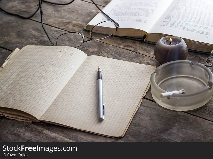 Books and Candle on wooden table