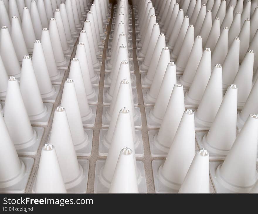 White cone warning signs standing in a row. White cone warning signs standing in a row