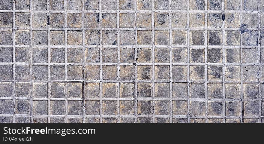 A section of squarish rough marble tiles, that are dirtied by use. A section of squarish rough marble tiles, that are dirtied by use